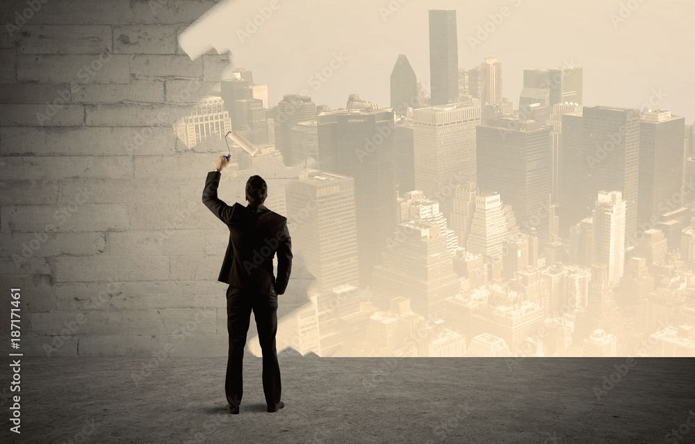 Salesman painting city scape on wall Salesman painting city scape on wall