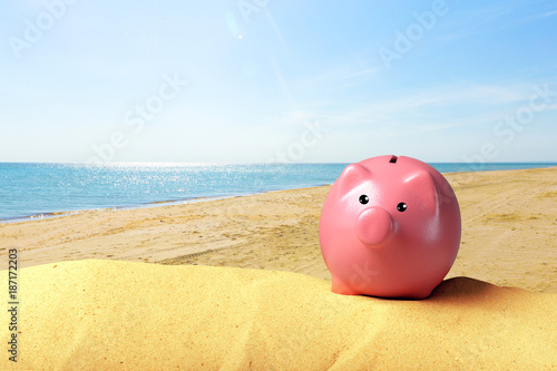 Piggy bank on a beach. Vacation savings concept © fotofabrika
