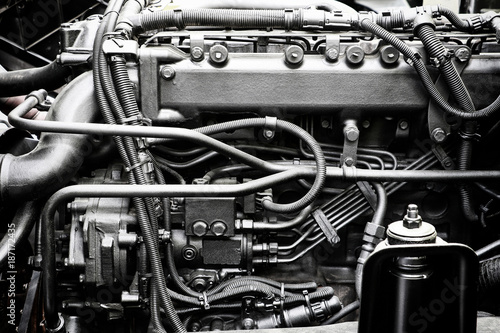 A classic fragment of diesel car engine or truck engine with copy space for text. Metallic background of the internal diesel truck engine or car engine.