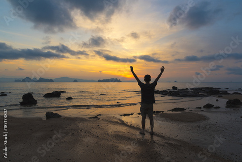 A man feeling success at the beach