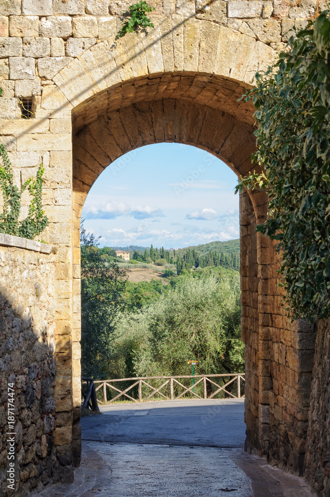 View of the Tuscan countryside through the Florentine Gate (Porta Fiorentina) - Monteriggioni, Italy