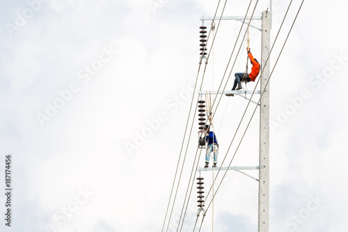 Asian men engineering working on high voltage workfield at countryside