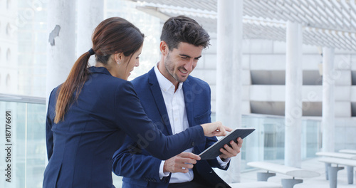 Картината върху платно Business people discuss on digital tablet computer outside office
