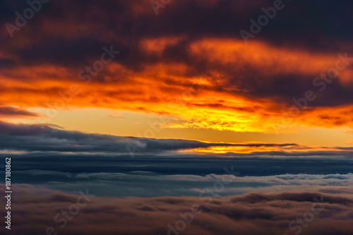 Sky during sunset view over the colored clouds. © olegmayorov