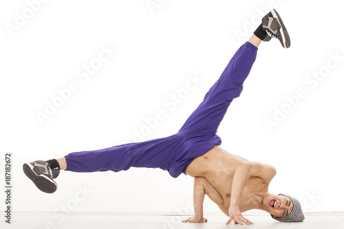 Young topless dancer sitting on his head with legs up and apart