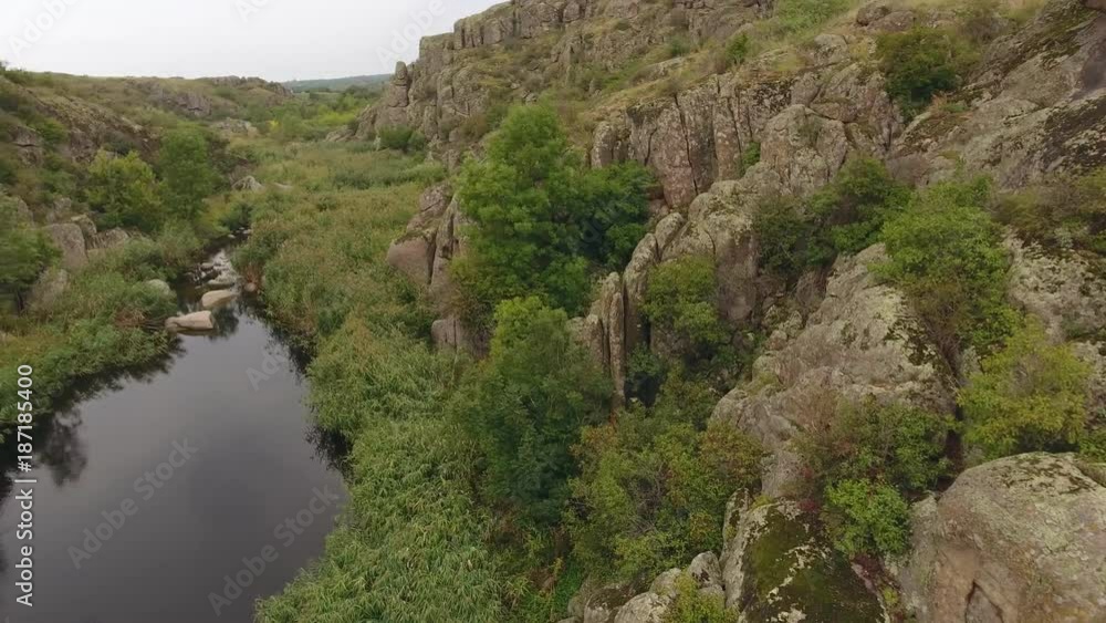 An astonishing view of a magic black river flowing in a narrow canyon among rocky mountains in Ukraine. The drone flies low and straight An astonishing view of a magic black river flowing in a narrow canyon among rocky mountains in Ukraine. The drone flies low and straight