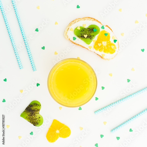 Delicious sandwich with citrus with kiwi fruit and fresh juice on white background. Flat lay, top view