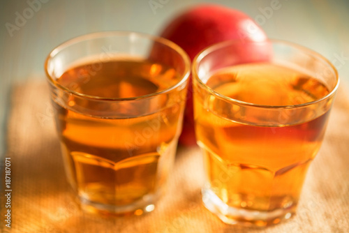 Fresh apple juice or cider in glasses on table
