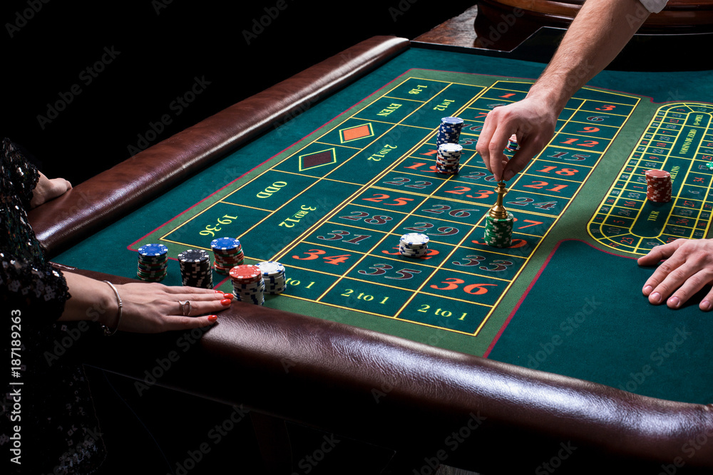 Croupier behind gambling table in a casino. Croupier behind gambling table in a casino.