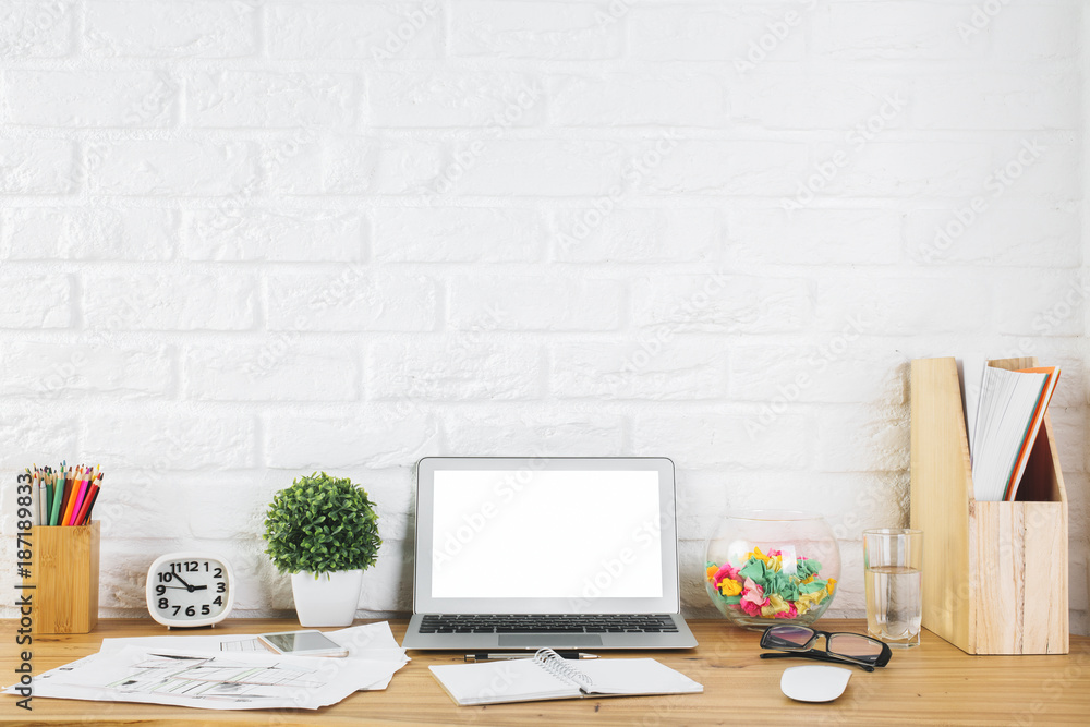 Creative designer workplace with blank laptop