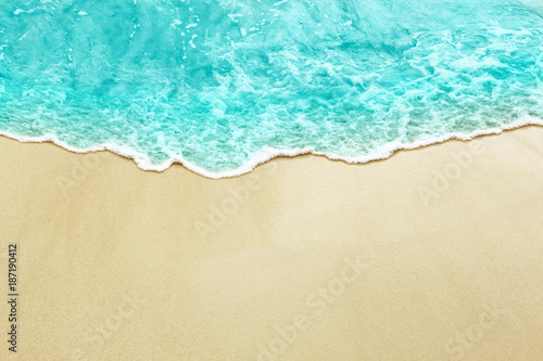 Turquise color sea wave on the sunny sandy beach © Mexrix