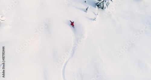 Person Snowboarding Down Slope Drone Aerial Birds Eye View Above White Powder Snow - Winter Extreme Sports Background