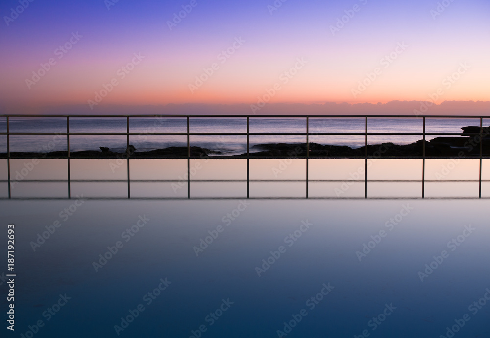 Pre dawn sky reflection in seaside pool