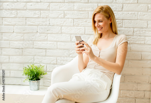 Blonde woman using mobile p...