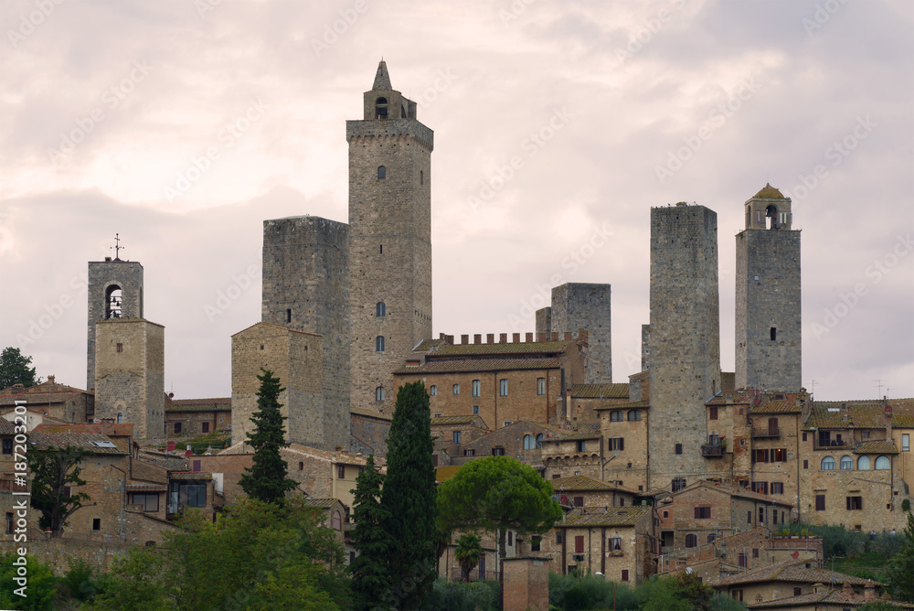 Towers of San Gimignano close up in the cloudy evening. Tuscany, Italy