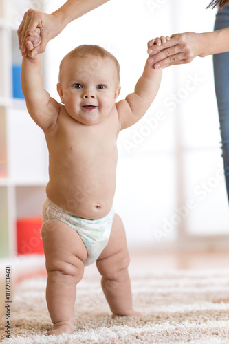Cute baby boy taking first ...