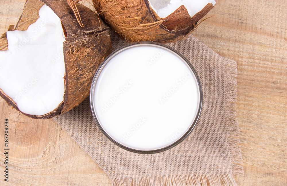 Coconut with coconut milk on wooden background. Coconut with coconut milk on wooden background.