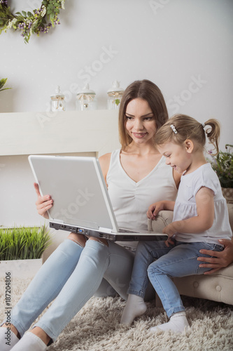 happy mother and child together looking laptop