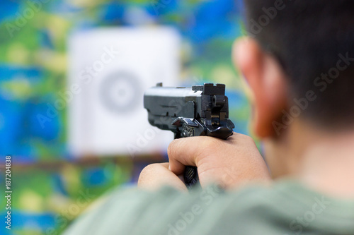 Blurred Image - Man practicing shooting in the amusement park. 