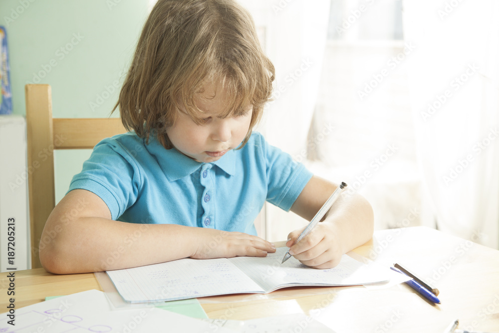 Little boy is doing his homework for elementary school Little boy is doing his homework for elementary school