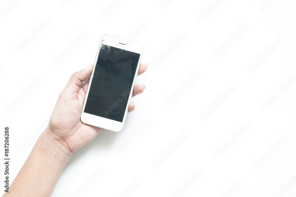 Woman's hand holding broken screen mobile device on white background Woman's hand holding broken screen mobile device on white background