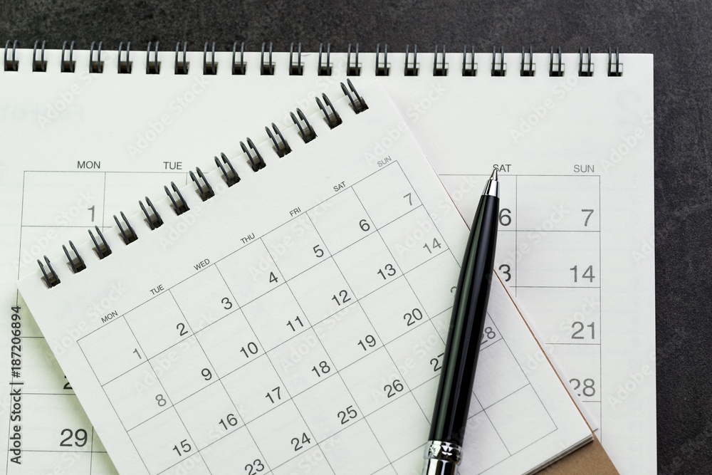 Calendars with pen on black background using as date orgainizer or year plan concept Calendars with pen on black background using as date orgainizer or year plan concept