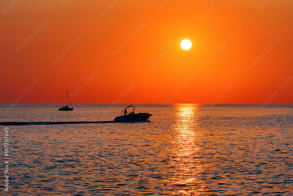 Summer. Sea. Sunset on the Black sea. Sochi. Krasnodar Krai. Russia. Yachts floating on the sea.