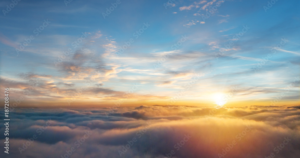 Beautiful aerial view above clouds with sunset