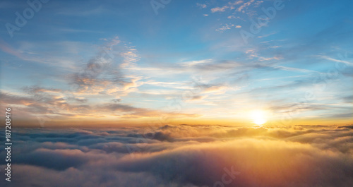 Beautiful aerial view above clouds with sunset