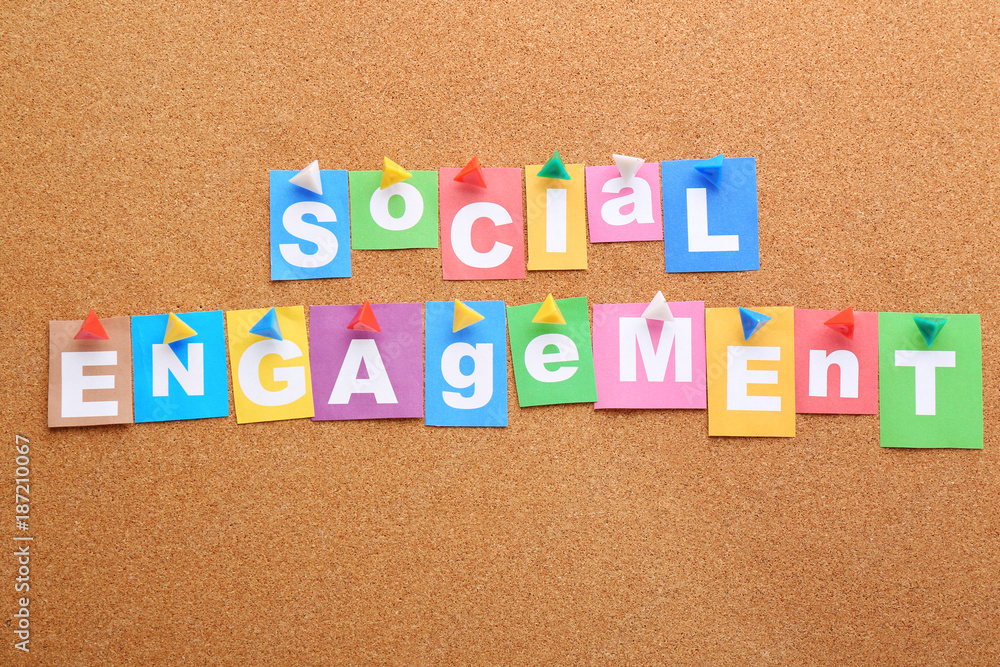 Text SOCIAL ENGAGEMENT made of paper letters on cork background Text SOCIAL ENGAGEMENT made of paper letters on cork background