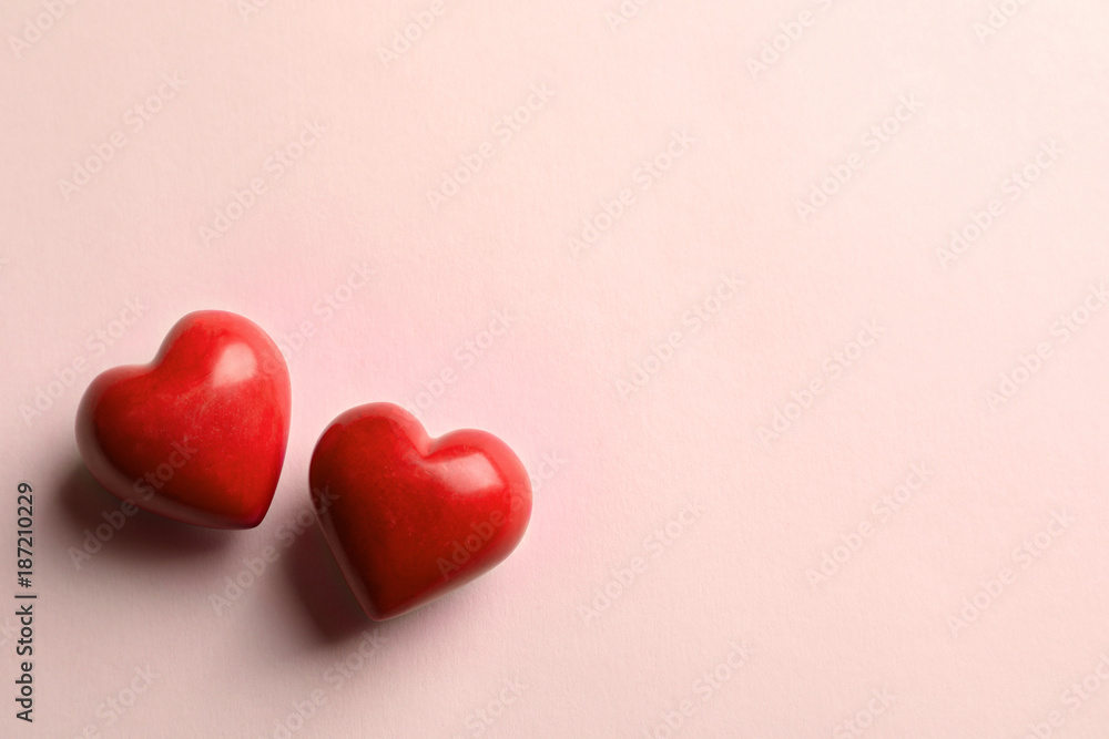 Fototapeta premium Two red hearts on light background