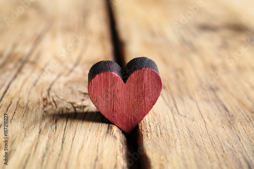 Small heart on wooden background