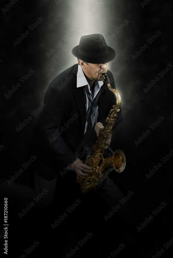 Naklejka premium Man playing on saxophone