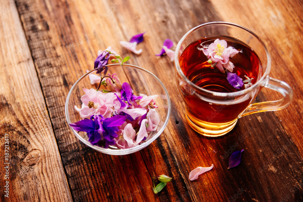 Calendula tea with calendula flowers on a wooden table Calendula tea with calendula flowers on a wooden table