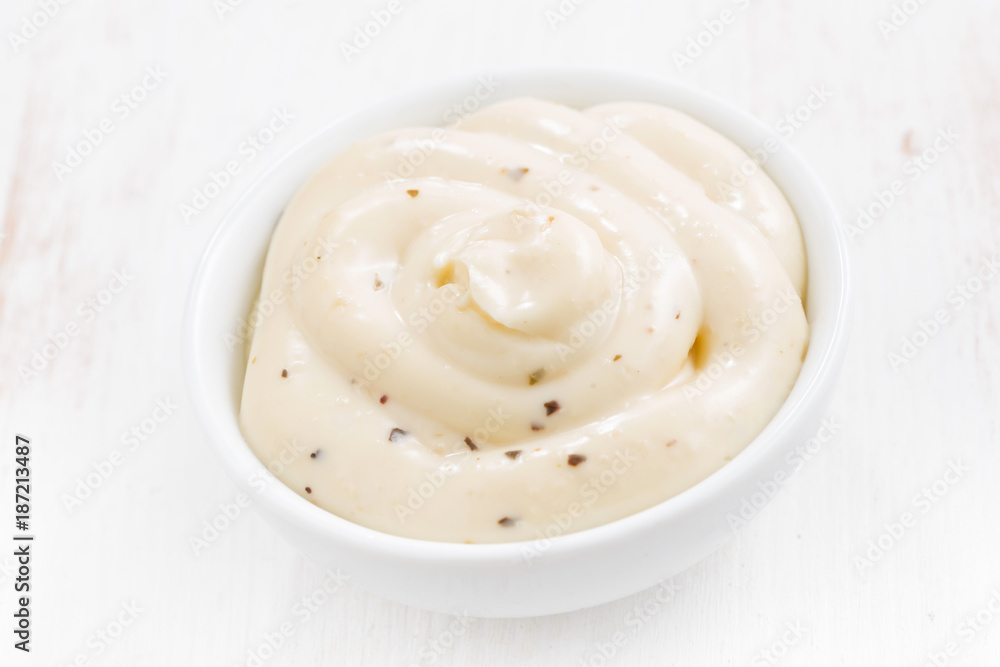 mayonnaise with herbs in a bowl, top view mayonnaise with herbs in a bowl, top view
