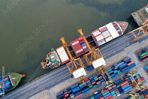 Aerial view of Containers yard in port congestion with ship vessels are loading and discharging operations of the tranport in international port.