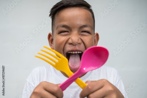 young asian boy with foek and spoon excited to eat © obeyleesin