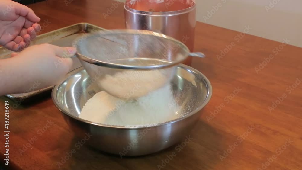 shaking flour into bowl shaking flour into bowl