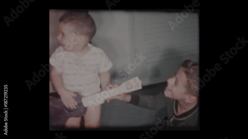 1961 2 year old little boy plays toy guitar