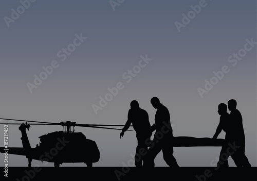 Soldiers with the wounded go to the helicopter
