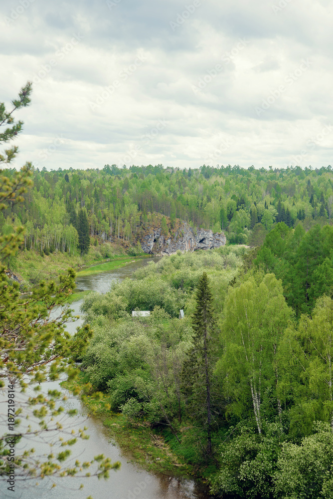Obraz premium The blue ribbon of the river from the height of the mountains. Wild nature, taiga. Tourism. Far East, Sakhalin Island, Russia.