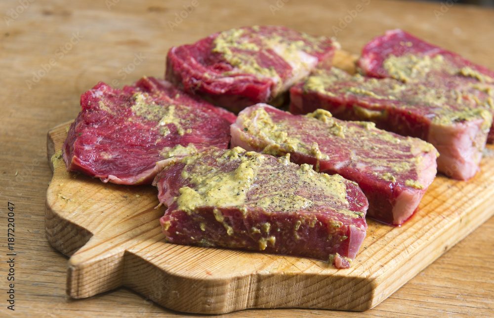 Raw beef schnitzel with spices ready for griil Raw beef schnitzel with spices ready for griil