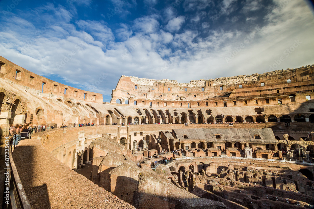 Tourists visiting the interior of Colosseum in Rome, Italy