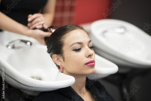 Washing beauty woman hair in hairdressing salon