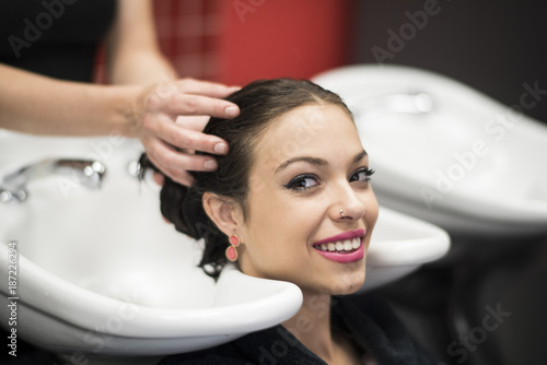 Washing beauty woman hair in hairdresser saloon
