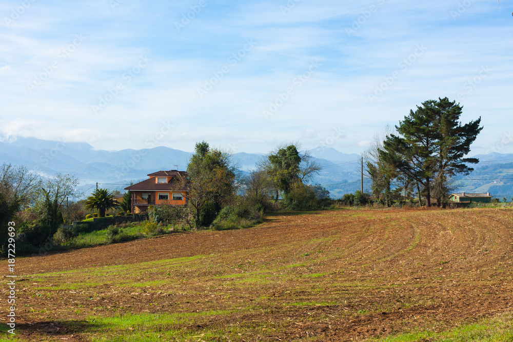Pastoral landscape of Escamplero village with mountains in the background. Asturias, Spain