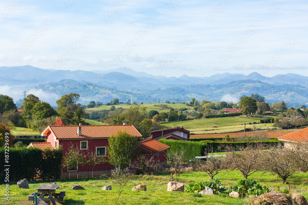 Pastoral landscape of Escamplero village with mountains in the background. Asturias, Spain