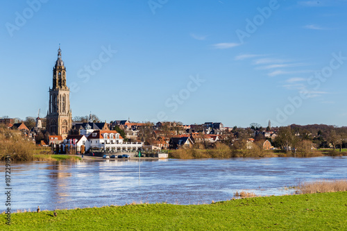 Landscape with a view on the flooded river Rhine and the small town  Rhenen in the Netherlands photo