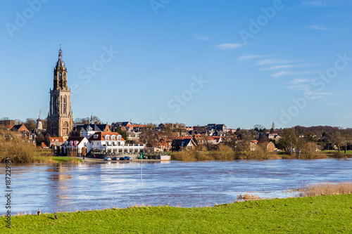 Landscape with a view on the flooded river Rhine and the small town  Rhenen in the Netherlands