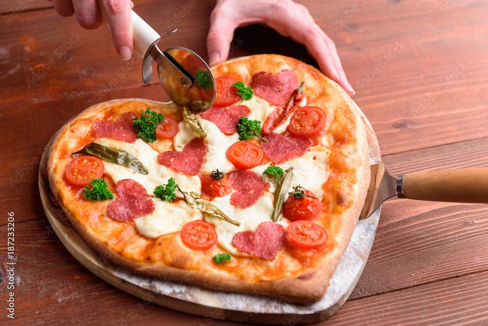 pizza heart for the Valentine's Day holiday. classic Italian pizza with salami and mozzarella